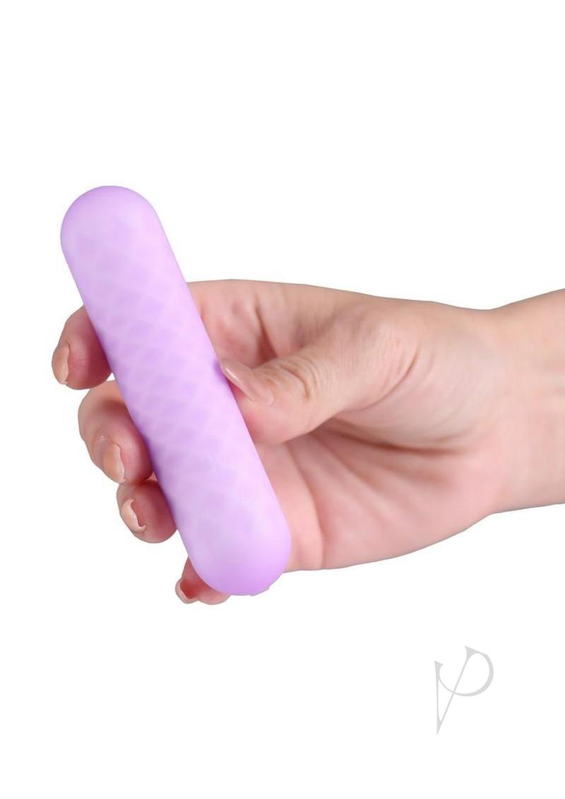Minnie's Spark flexible bullet vibrator in purple, held in one hand for scale