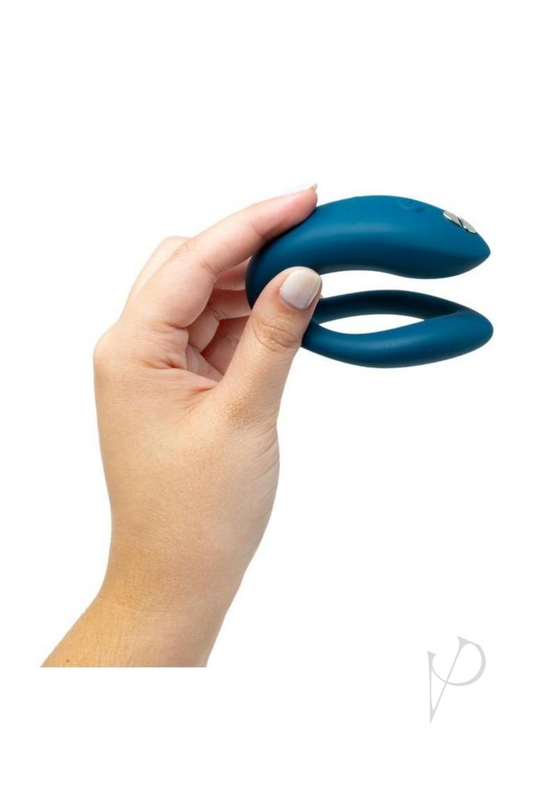 We-Vibe Sync O couples vibrator in velvet green, held in one hand